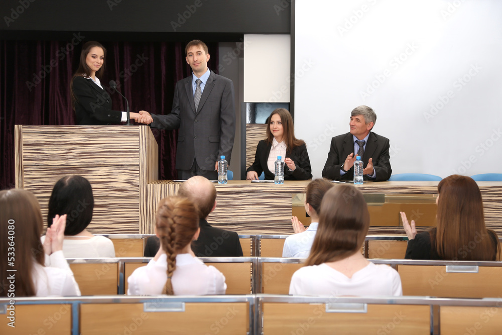 Business people at tribune in conference room