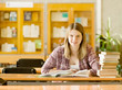 © Ermolaev Alexandr - Happy girl with books at the library. looking at camera
