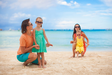 Young beautiful family with two kids on tropical vacation