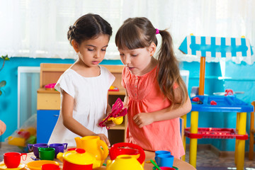 Two little girls playing in daycare