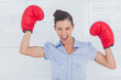 © WavebreakmediaMicro - Businesswoman in boxing gloves cheering