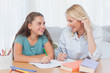 © WavebreakmediaMicro - Cheerful mother and daughter writing together