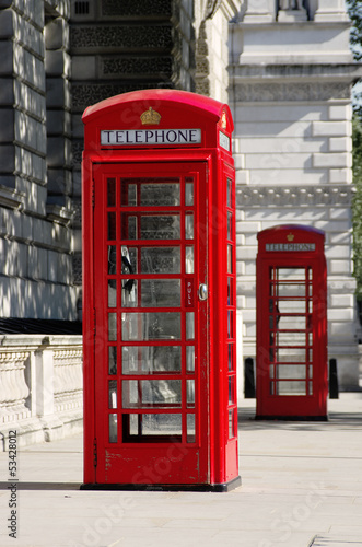 Fototapeta na wymiar Red Phone Boxes Old Style In London