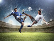 © Sergey Nivens - two football players striking the ball
