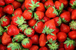 Fresh strawberry fruit as a backdrop. 