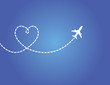 Airplane flying in dark blue sky with love shaped smoke trail