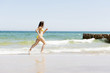 © Piotr Marcinski - happy woman running on the beach