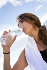  Woman drinking water after sport activities