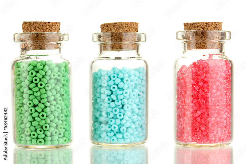 Little bottles full with colorful beads isolated on white