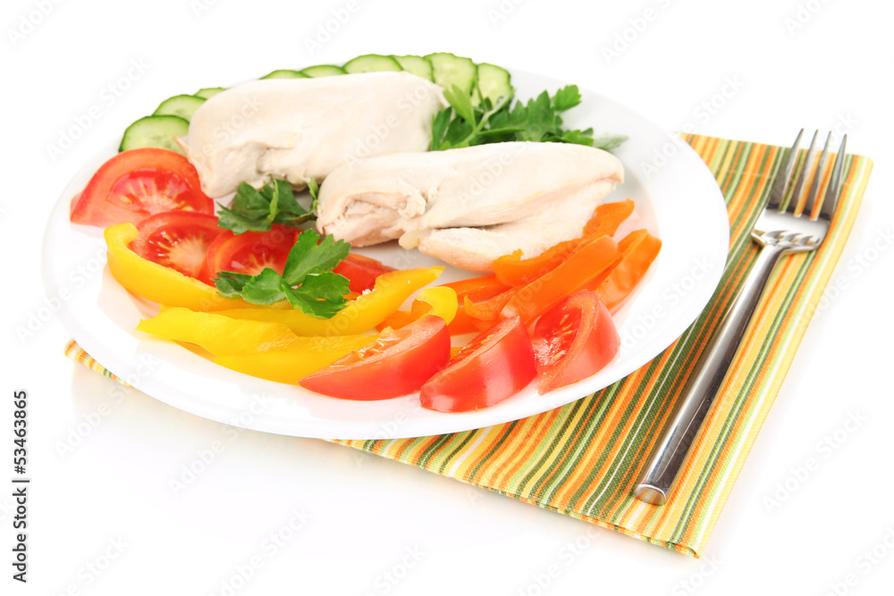 Boiled chicken breast on plate with vegetables close up
