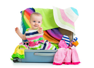 Fototapete - Baby girl sitting in suitcase with  things for vacation travel