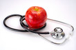 A stethoscope with a red apple