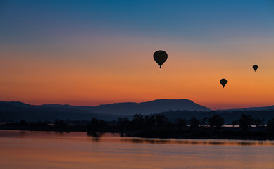 Wall Mural - Hot air balloon over the mountain at sunset