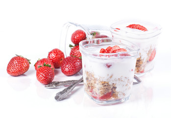 Wall Mural - muesli, strawberries and yogurt on a white background in glasses