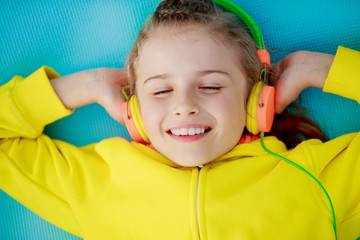 Wall Mural - Young girl enjoying music