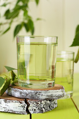 Poster - Glasses of birch sap on green wooden table