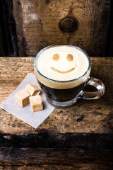 Poster - Cappuccino coffee with smile drawing art foam in glass small cup