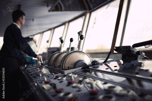 Fotografía Navigation officer driving ship on the river.