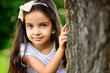 © spass - Portrait of hispanic girl in sunny park
