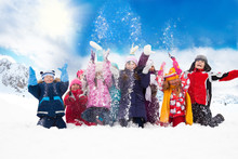 Group Of Happy Kids Throwing Snow
