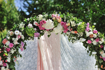 Wall Mural - Wedding Arch with flowers on the grass
