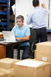 © Monkey Business - Worker In Warehouse Wearing Headset And Using Laptop
