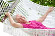 © Monkey Business - Senior Woman Relaxing In Beach Hammock