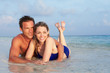 © Monkey Business - Romantic Couple Lying In Sea On Tropical Beach Holiday