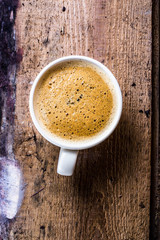 Poster - Closeup cup of espresso on old wooden table over grunge backgrou