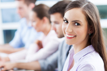 Poster - Businesswoman with coworkers in background