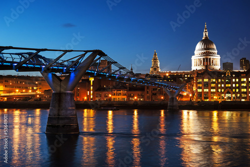 Obraz w ramie Millennium bridge and St Pauls cathedral at dusk.