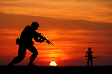 Wall Mural - Soldiers silhouette at sunset