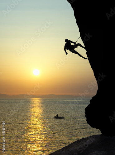 Fototapeta na wymiar Free climbing at sunset