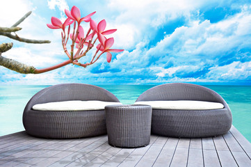 Wall Mural - Rattan sofa seats in front of the sea