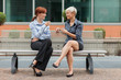 © Francesco83 - Businesswoman sitting outside on a bench and talking