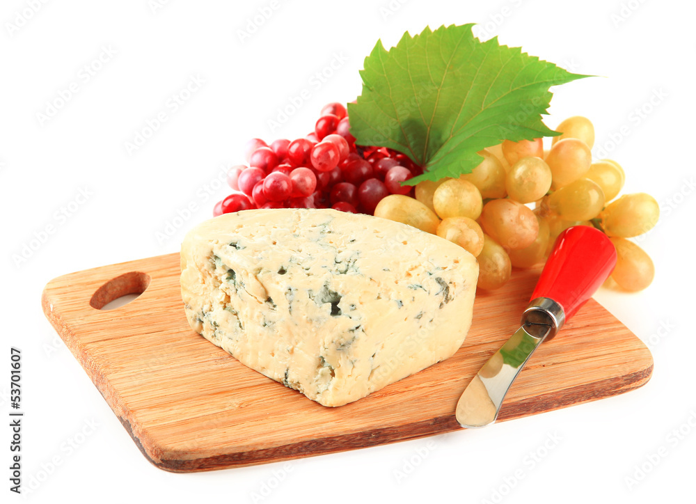 Tasty blue cheese and grape on cutting board, isolated on white