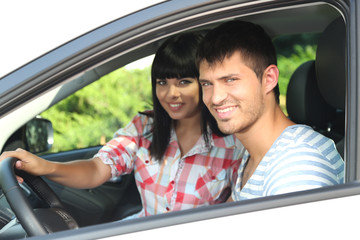 Wall Mural - Beautiful happy young couple driving car