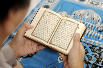 Young Man Reading The Holy Koran