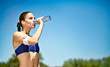 © luckybusiness - Woman drinking water after sport activities