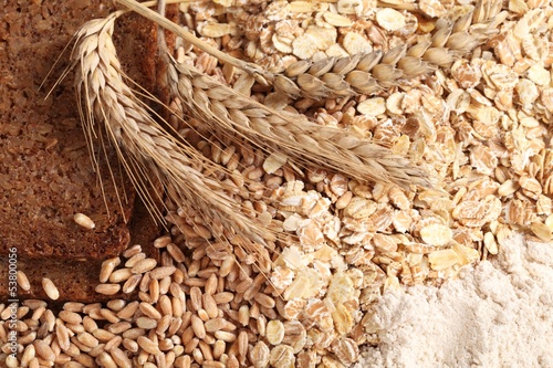 Fototapeta na wymiar Close-up of rye bread, wheat, cereal flakes and wholegrain flour