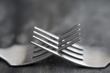 Macro image of cutlery forks on rustic background