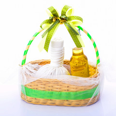 gift set of herbal compress ball and massage oil for spa treatme