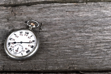 vintage pocked watch on old wood