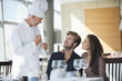 © onoky - Chef talking to couple at restaurant