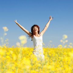 Wall Mural - Cute woman in the field with flowers