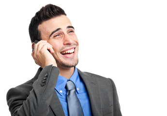 Wall Mural - Smiling businessman talking at the phone isolated on white