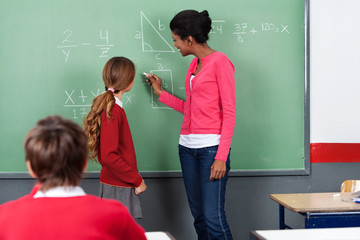 Teacher Teaching Mathematics To Students On Board