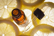 Essential oil amber glass bottle with slices of lemon