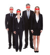 © Andrey Popov - Group Of Business People's Eyes Covered With Ribbon