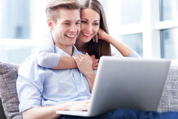 Poster - Couple on sofa with laptop